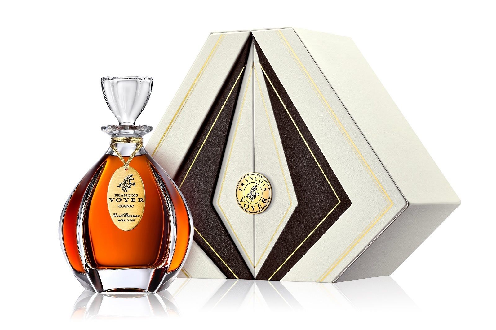 Elegant cognac bottle with a geometric gift box, featuring gold and brown accents.